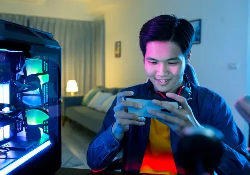  A guy having fun playing mobile games on his mobile phone
