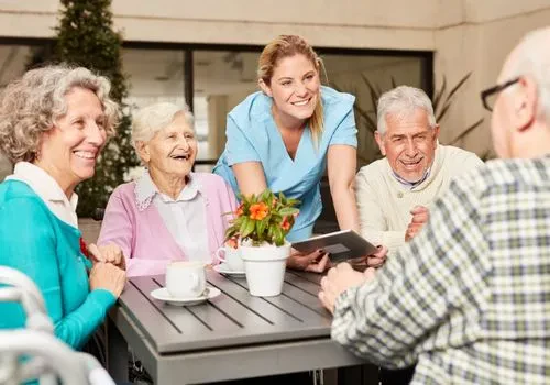 A group of senior citizens, some with limited mobility, laughing at something
